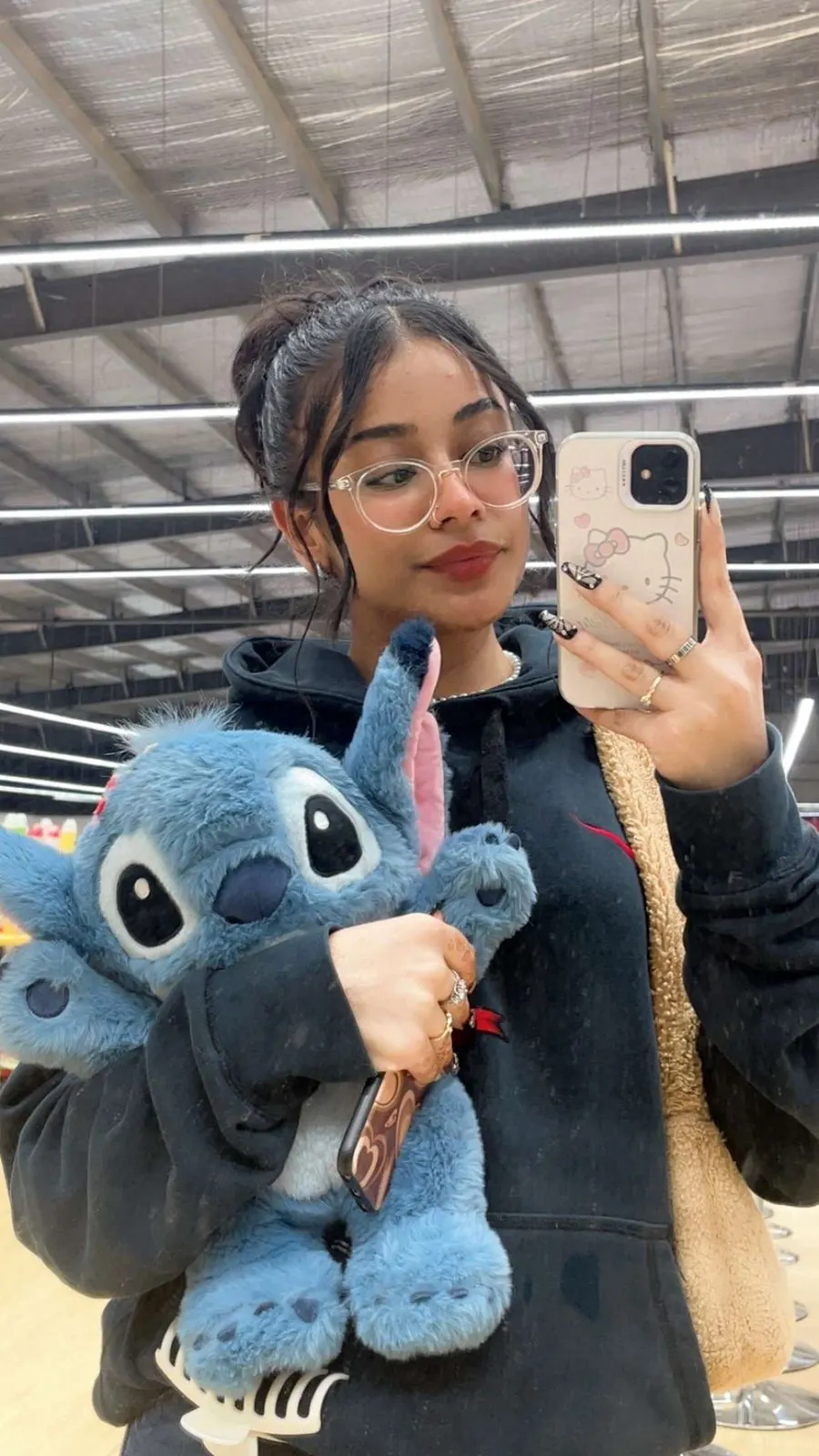 Girl taking a mirror selfie with her Fluffy Stitch plushie