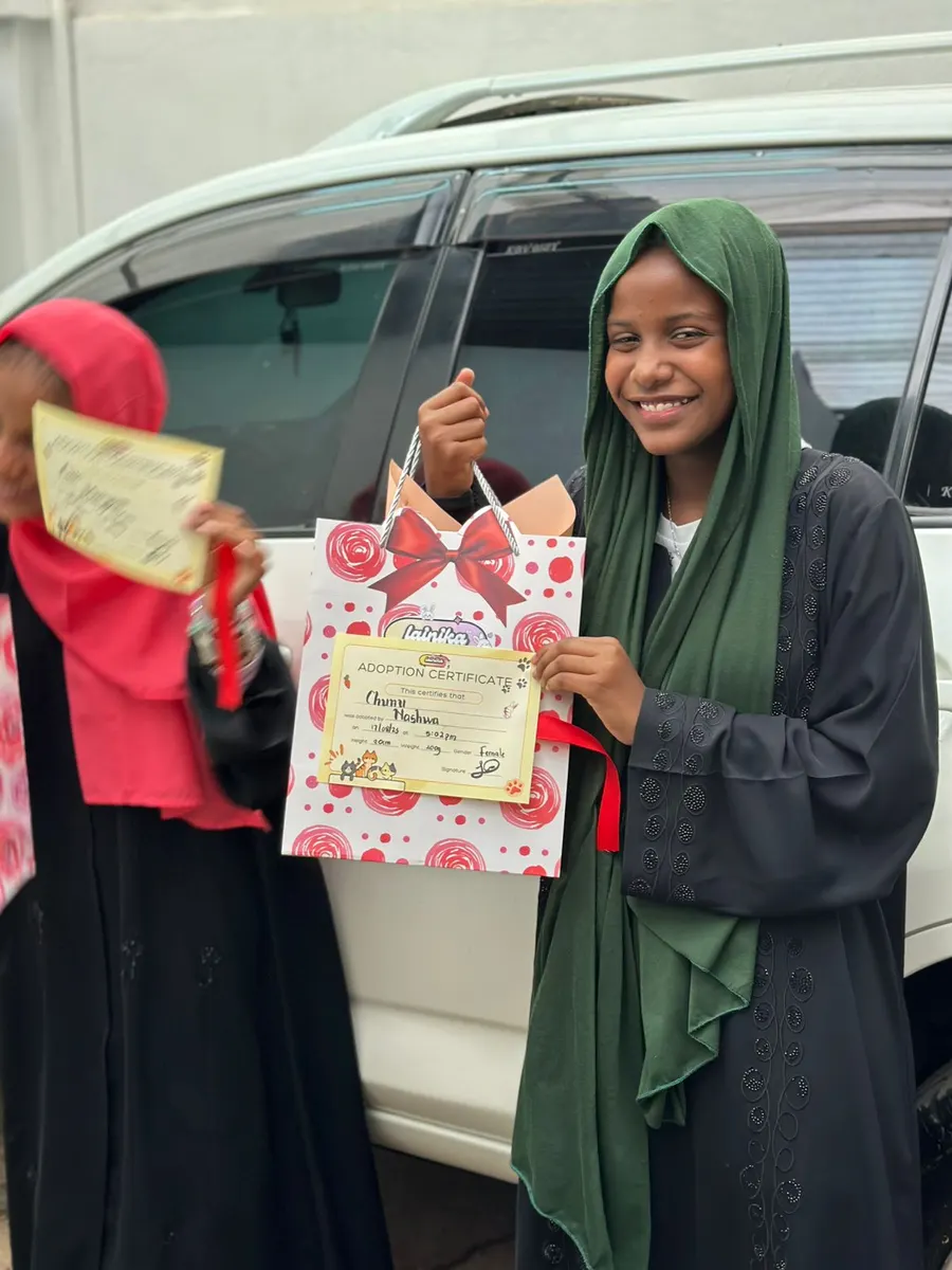Two young girls smiling with their Lainika bags