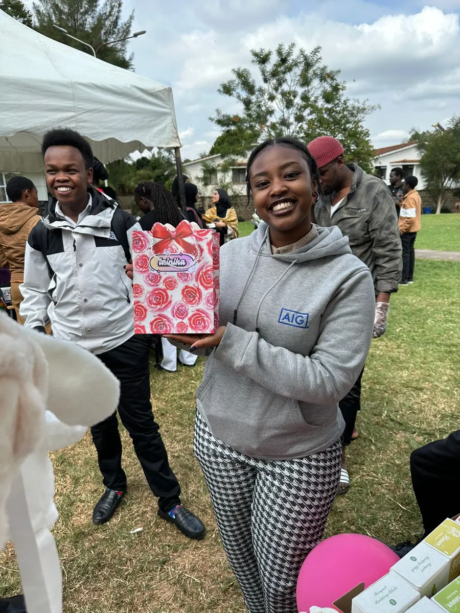A happy customer smiling with her new bunny plushie