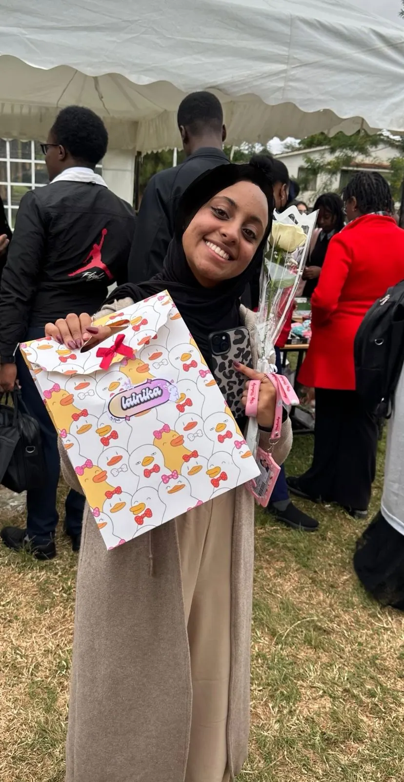 A happy customer smiling with her plushie