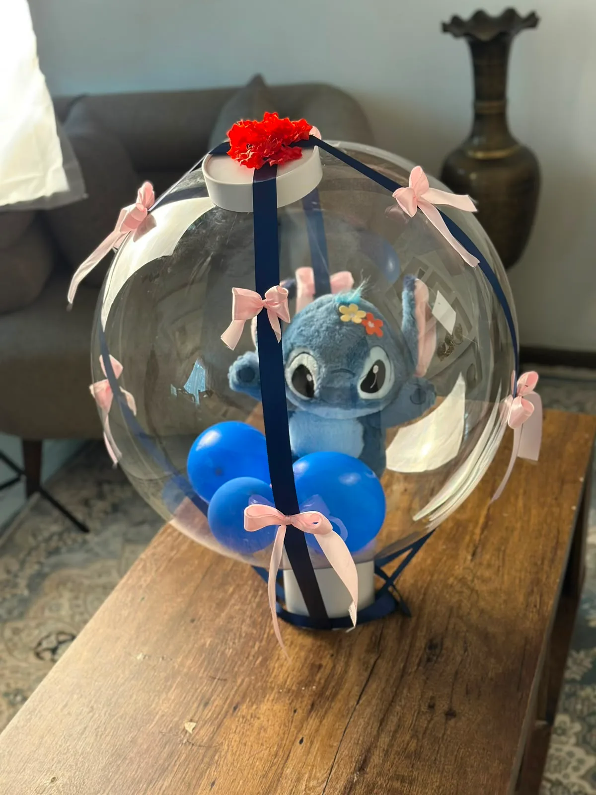 A Stitch plushie floating inside the Lainika Sphere, wrapped in ribbon