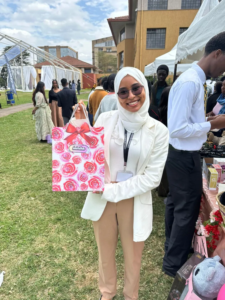 A happy customer smiling with her plushie